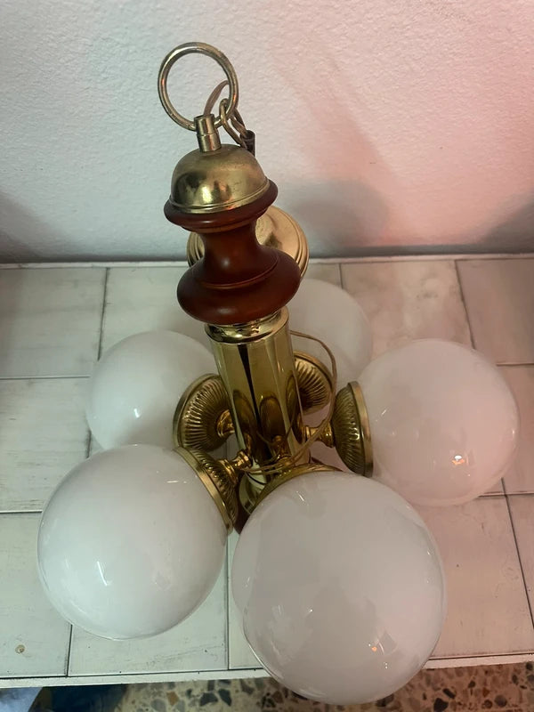 Vintage chandelier — brass arm and globe fitting detail
