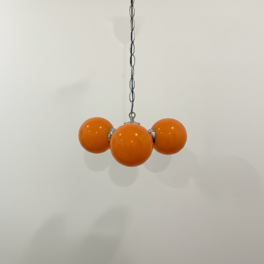 Hero shot of Space Age pendant lamp with three orange glass globes